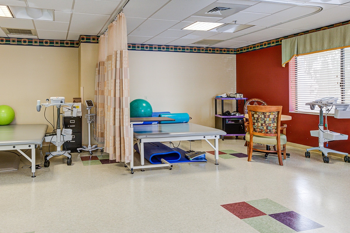 Rehab gym with tables and chairs and balls